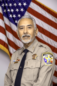 Picture of Constable Lopez in front of a USA flag