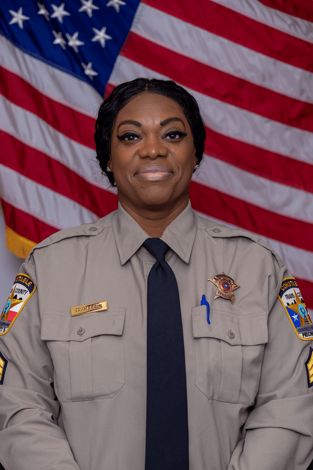 Official Portrait of Sgt. Kasben Harris in front of the American flag