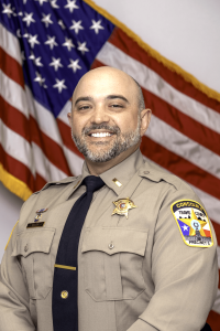 Official Portrait of Lt. Carl Eller in front of the American flag