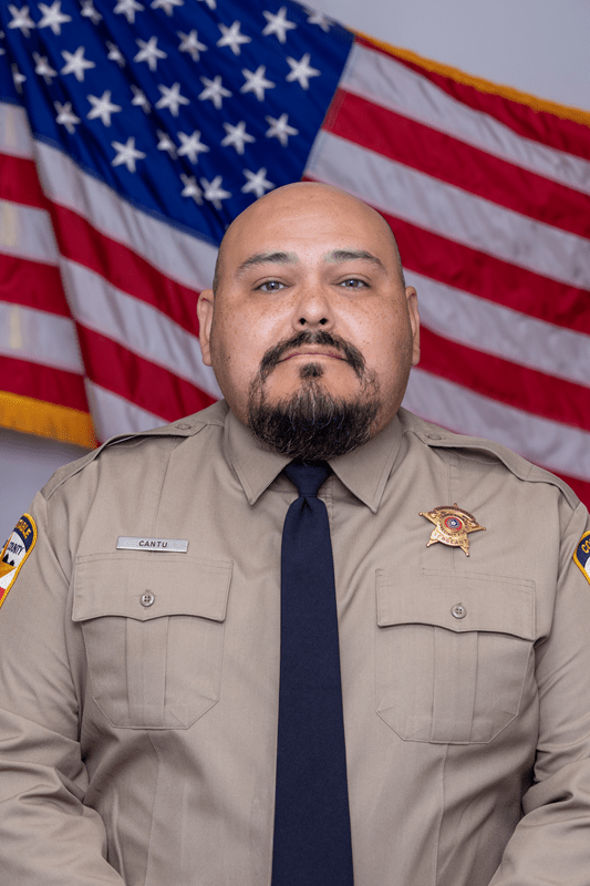 Official Portrait of Sgt. Robert Cantu in front of the American flag