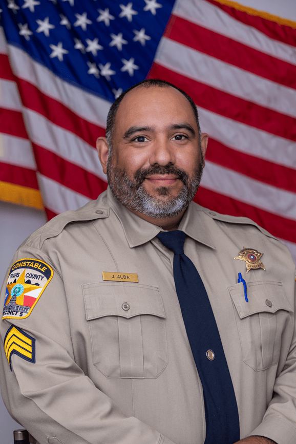 Official Portrait of Sgt. Josh Alba in front of the American flag