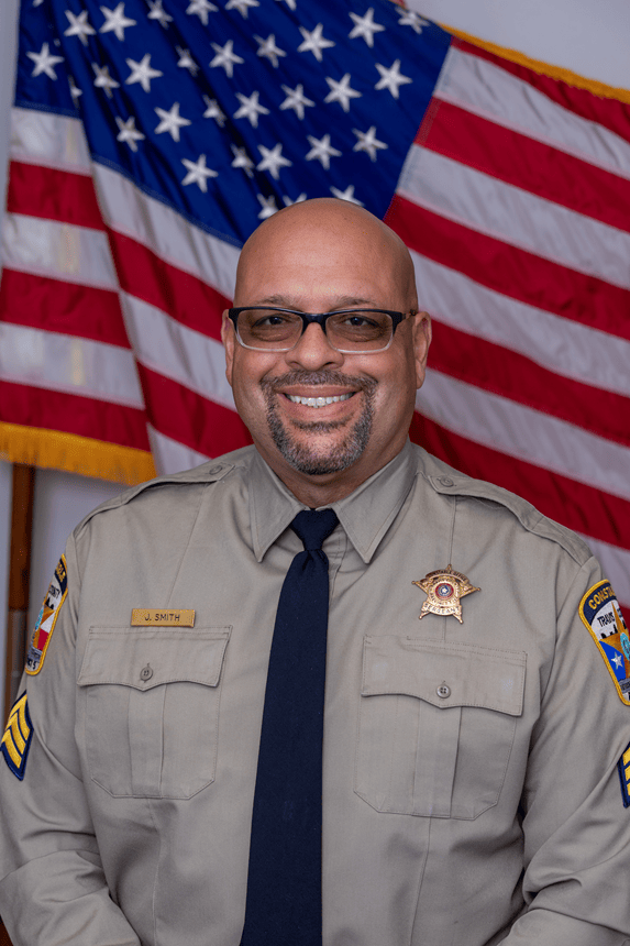 Official Portrait of Sgt. Juilen Smith in front of the American flag